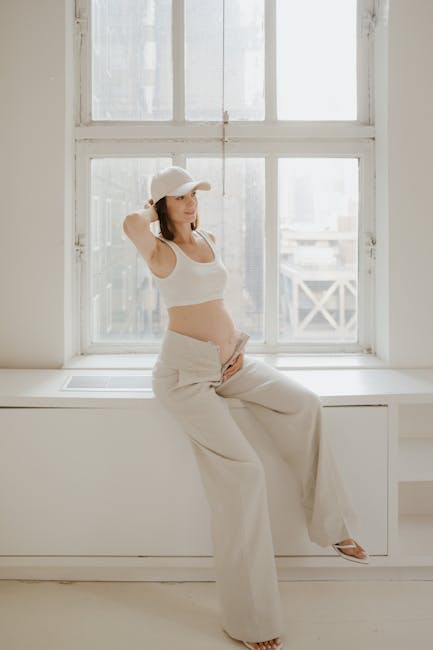 A serene woman in a comfortable yoga pose in a warmly lit, minimalist room